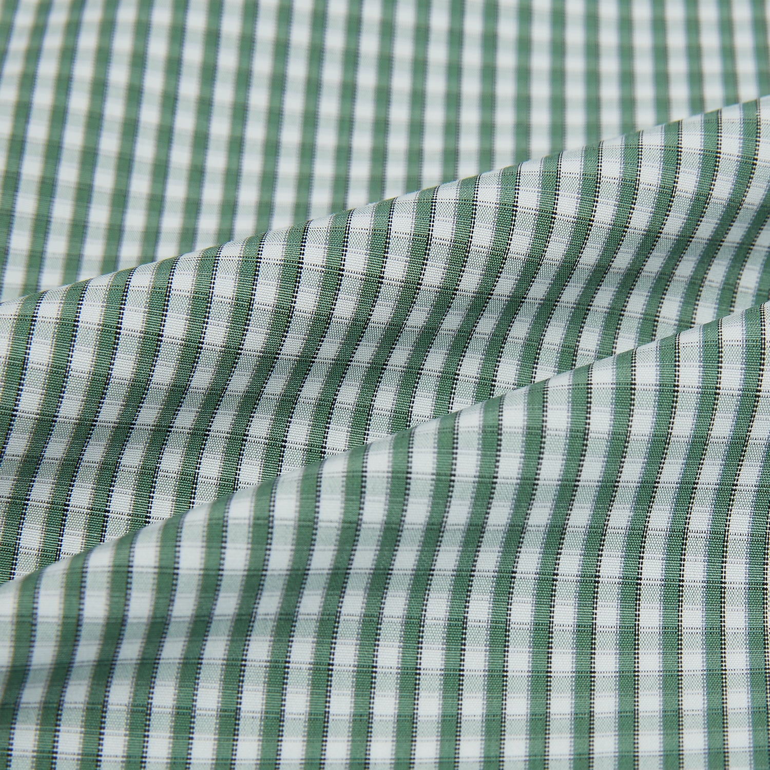 View 8 of product The MELON GREEN MICRO SHADOW CHECK WESTMINSTER SHIRT by Turnbull & Asser is a long-sleeved, button-up shirt with a green and white checkered pattern, pointed collar, and buttoned cuffs, shown on a white background.