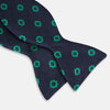 View 3 of product The Navy and Green Motif Silk Bow Tie by Turnbull & Asser features geometric floral patterns, ideal for formalwear, and is shown on a white background.