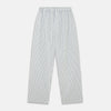 View 6 of product The Turnbull & Asser Green and Blue Check Cotton Hyde Pyjama Set for men features a long-sleeve, button-up top and pants with contrasting dark piping, shown laid flat on a white background.
