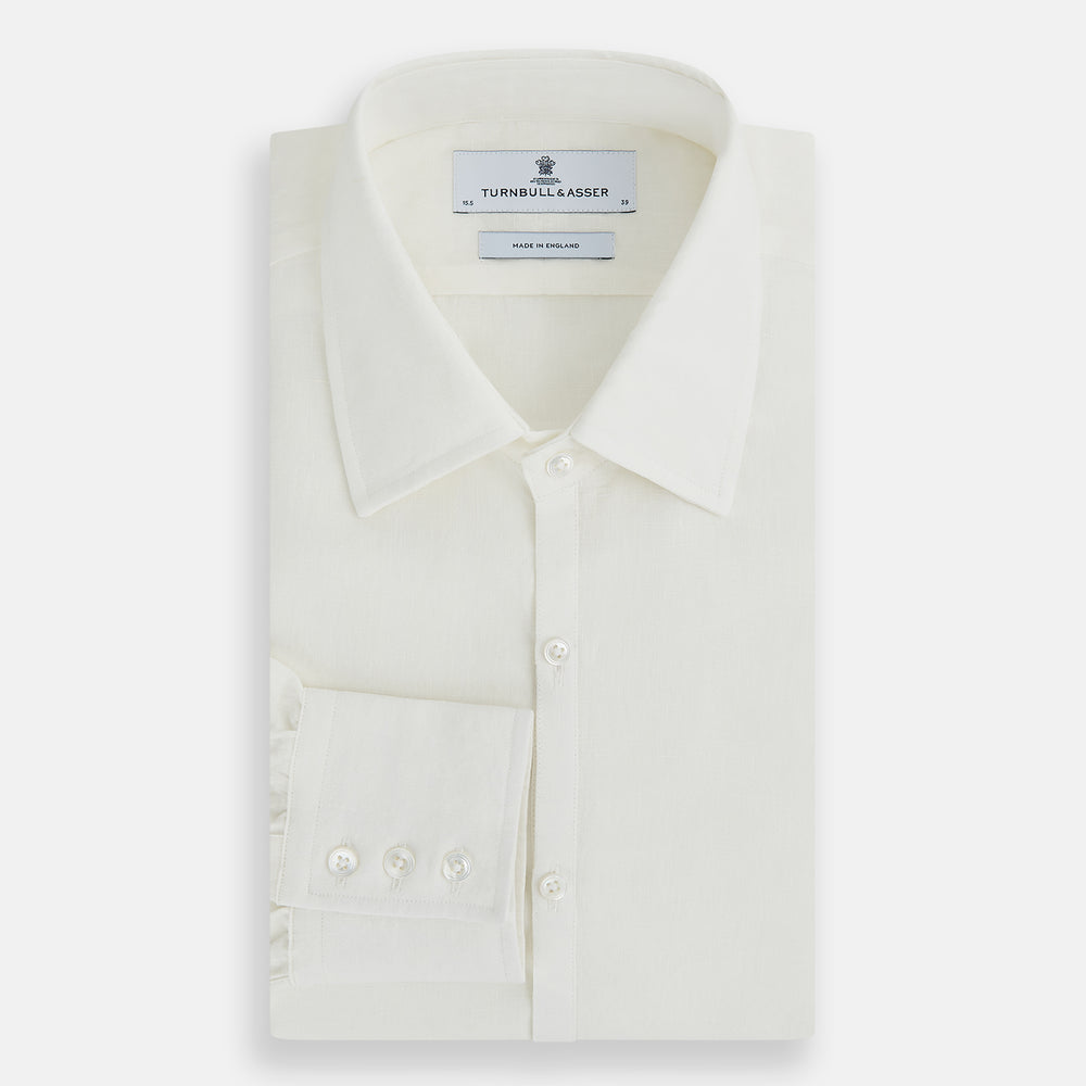 The Vanilla Linen Westminster Shirt by Turnbull & Asser is a long-sleeve, white button-up with a Turnbull collar, buttoned cuffs, and straight hem, highlighting British craftsmanship against a plain white background.