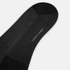 View 3 of product The Turnbull & Asser Charcoal Melange Houndstooth Long Sock is knee-high, with a subtle dark houndstooth pattern and solid black toe, heel, and cuff, shown on a white background.