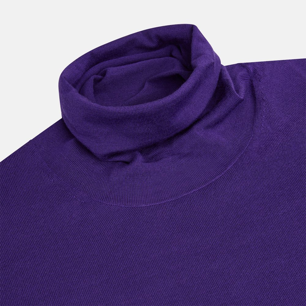 The Turnbull & Asser Purple Fine Merino High Neck Jumper is shown on a white background, featuring a plain, long-sleeved design that highlights the classic elegance of Italian knitwear.