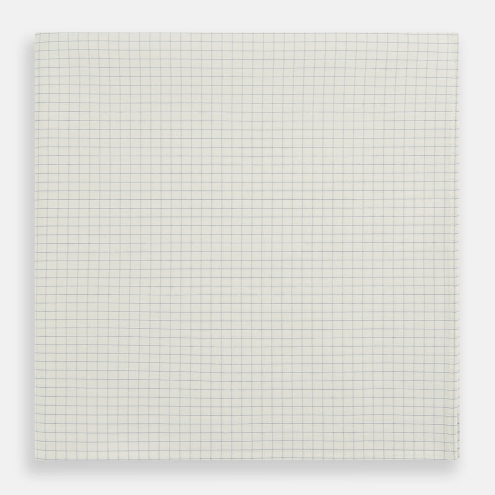 The Turnbull & Asser Pale Blue Graph Check Handkerchief features a refined white background with evenly spaced pale blue grid lines, evoking the minimalist elegance of classic graph paper in a luxurious accessory.