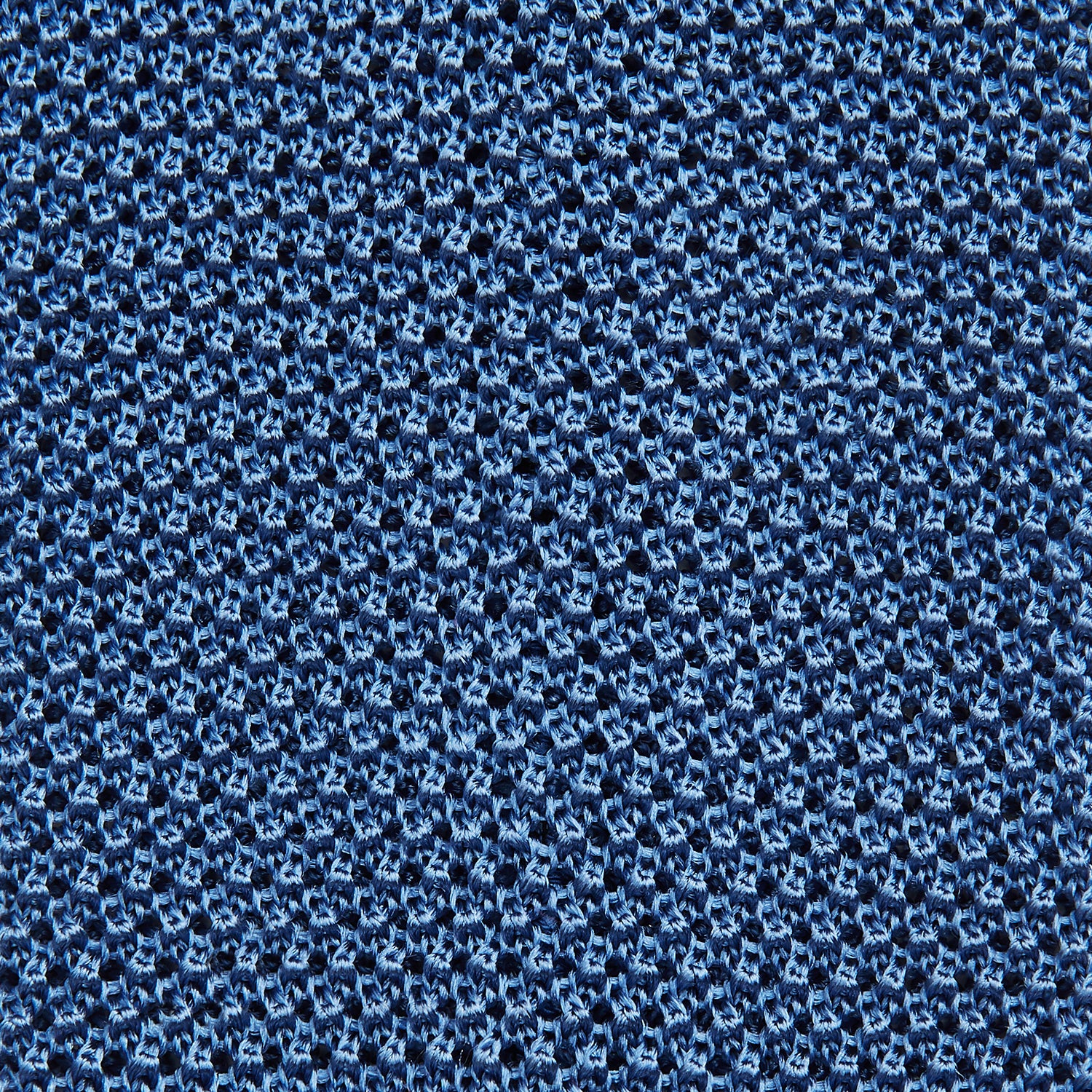 View 3 of product The Turnbull & Asser Knitted Mid Blue Silk Plain Tie features a textured knit and is shown rolled up on a plain white background—a refined accessory that pairs perfectly with formal shirts.