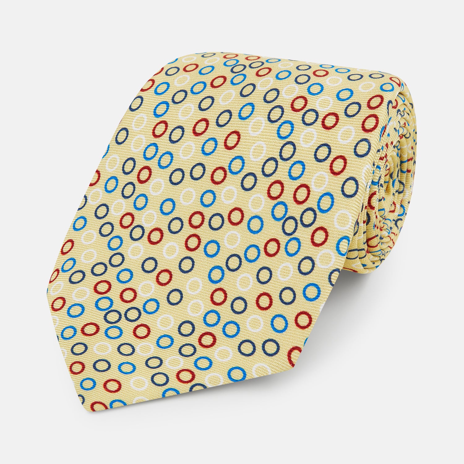 View 1 of product The Turnbull & Asser Multi-coloured Circle Yellow Silk Tie, crafted from fine English silk, features a vibrant pattern of multicoloured circles and is elegantly displayed rolled on a white background.