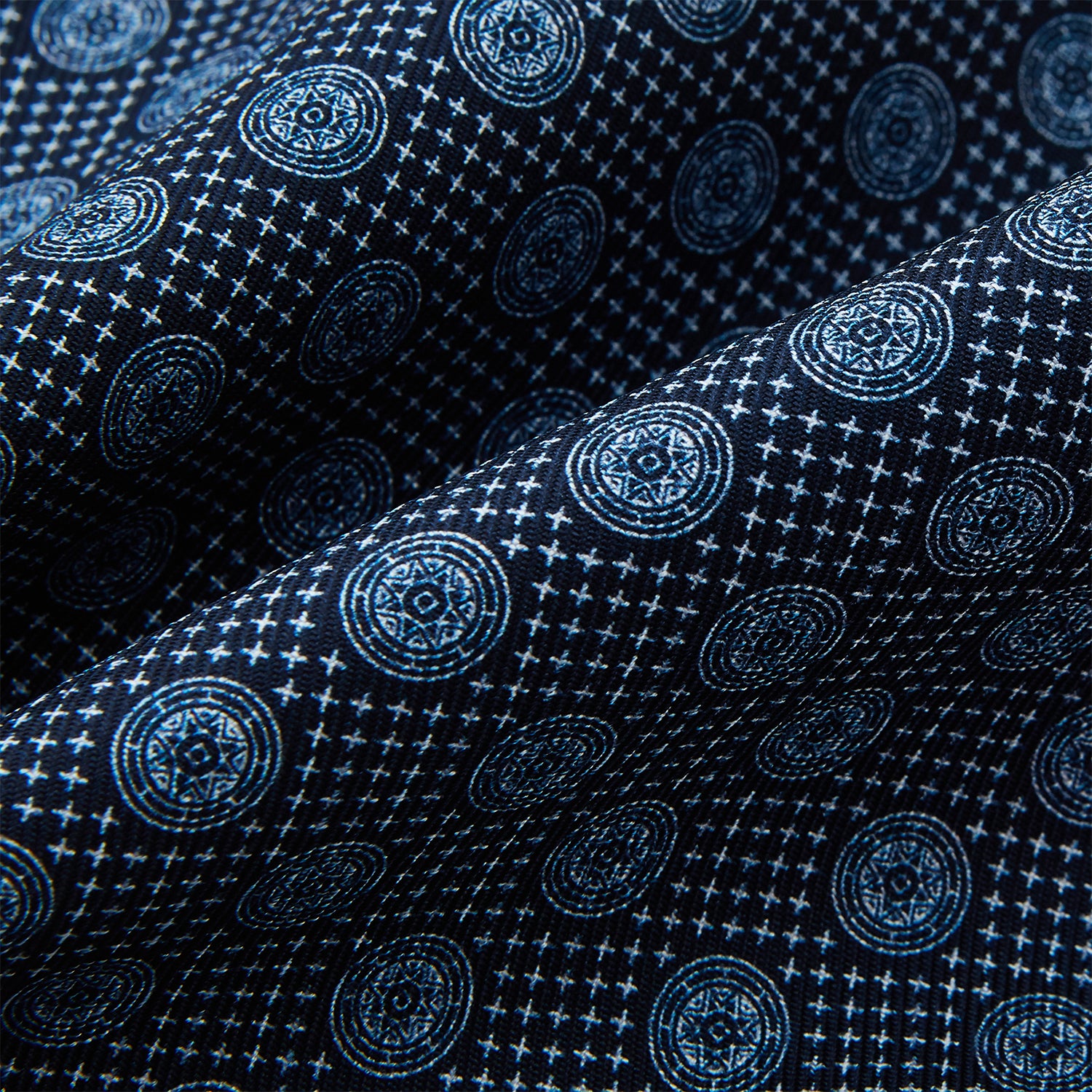 View 4 of product The Turnbull & Asser Navy Medallion Silk Cravat features a white geometric and circular pattern, its classic design and rich navy hue echoing refined British elegance.