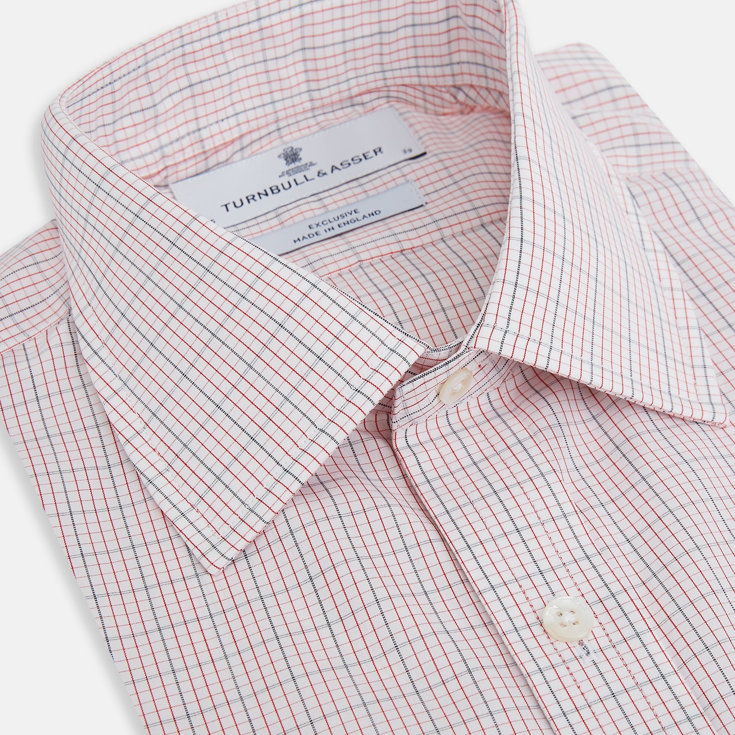 View 2 of product The Turnbull & Asser Red Micro Graph Check Mayfair Shirt is a long-sleeved, button-up Italian cotton shirt with a spread collar and buttoned cuffs, shown on a plain white background.