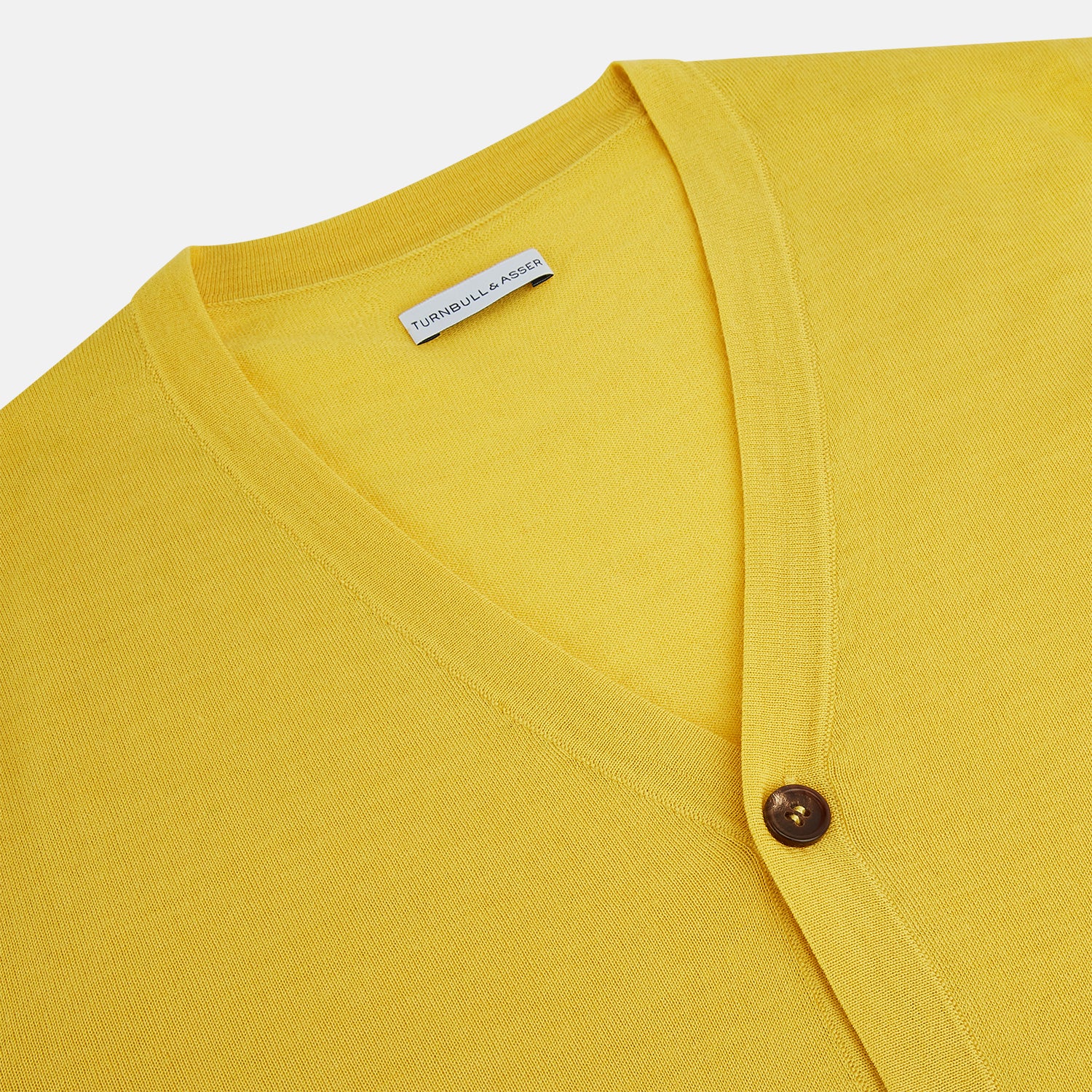 View 2 of product The Turnbull & Asser Canary Yellow Fine Merino V-Neck Cardigan features long sleeves, a button front with brown buttons, and ribbed cuffs and hem, displayed on a plain white background.