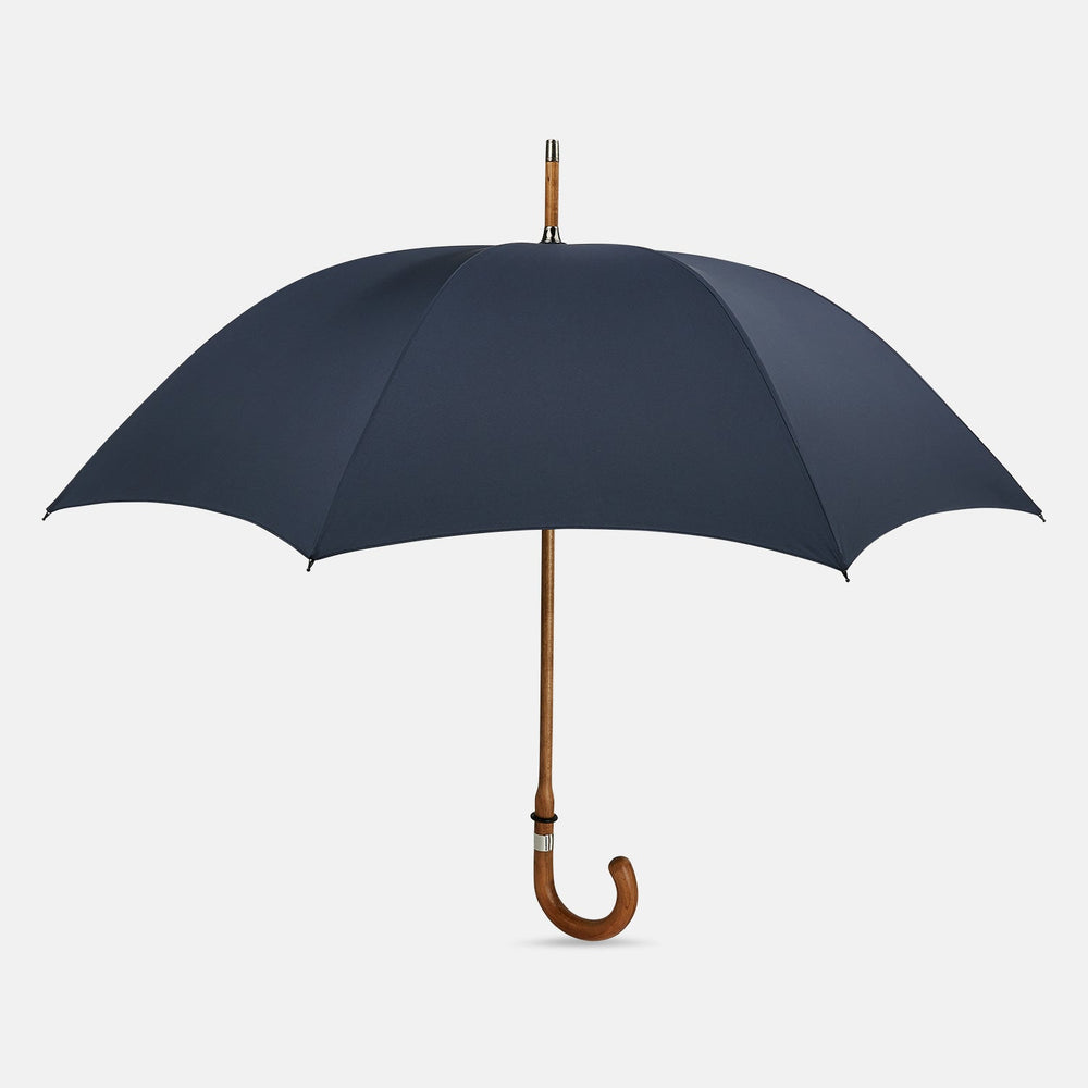 The Turnbull & Asser Navy Umbrella with Maple Crook Handle is open against a white background—an elegant men's accessory inspired by classic style.