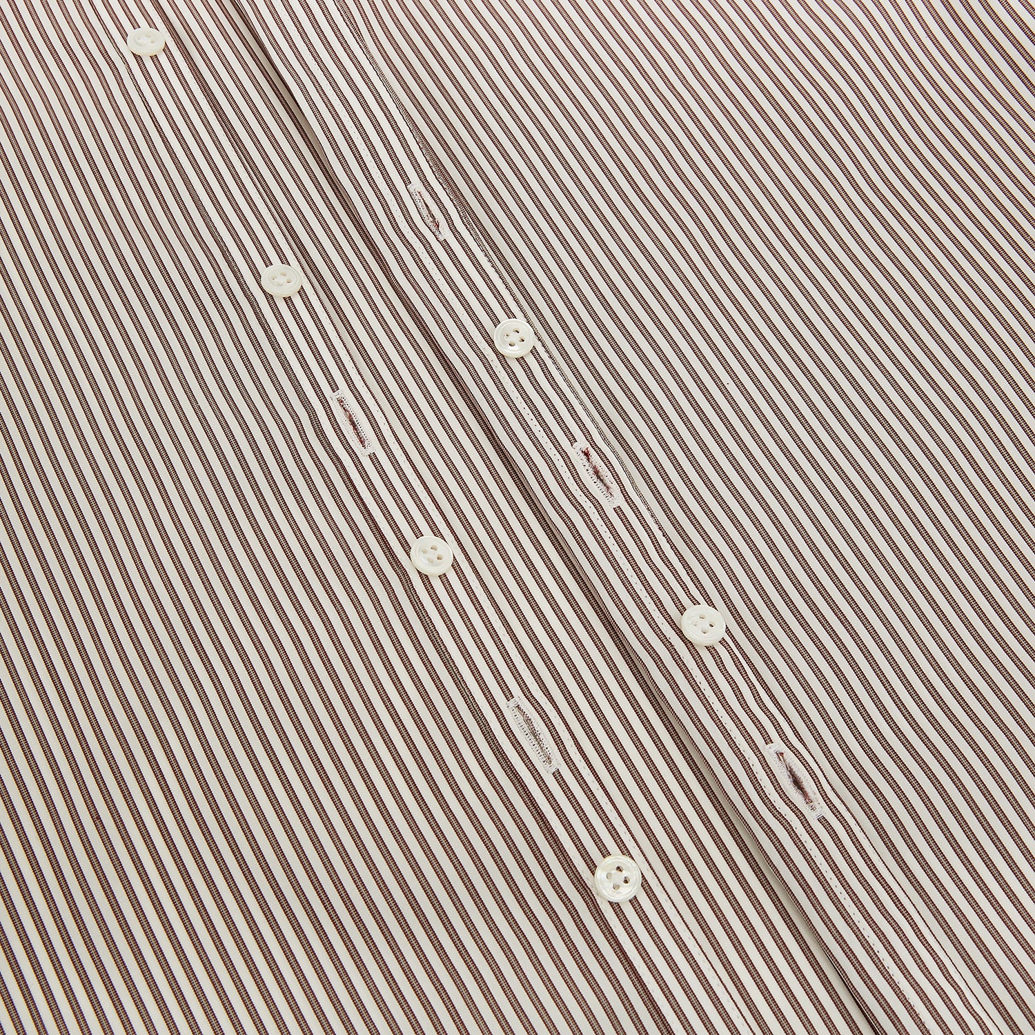 View 7 of product The Burgundy Halo Stripe Westminster Shirt by Turnbull & Asser features long sleeves, a button-up front, a Westminster collar, and thin vertical brown and white stripes, shown on a plain white background.