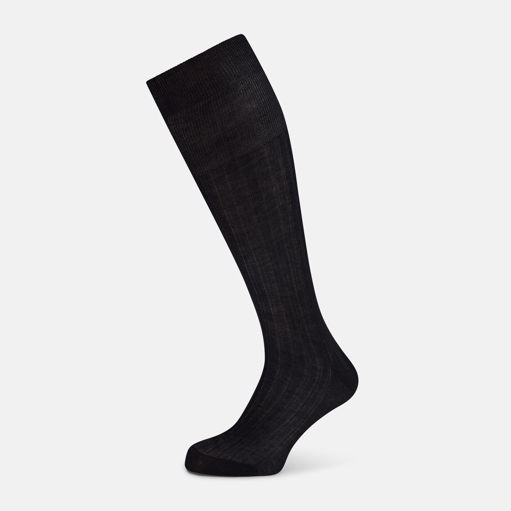 A single Midnight Blue Long Sock by Turnbull & Asser is shown on a white background, showcasing a ribbed texture and a fitted design that extends from the foot to the top of the calf.