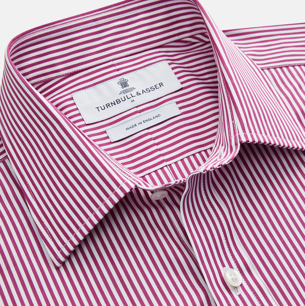 The Turnbull & Asser Purple & White Stripe Weekend Fit Shirt features a Derby collar, chest pocket, and 1-button cuffs—ideal for casual weekends.