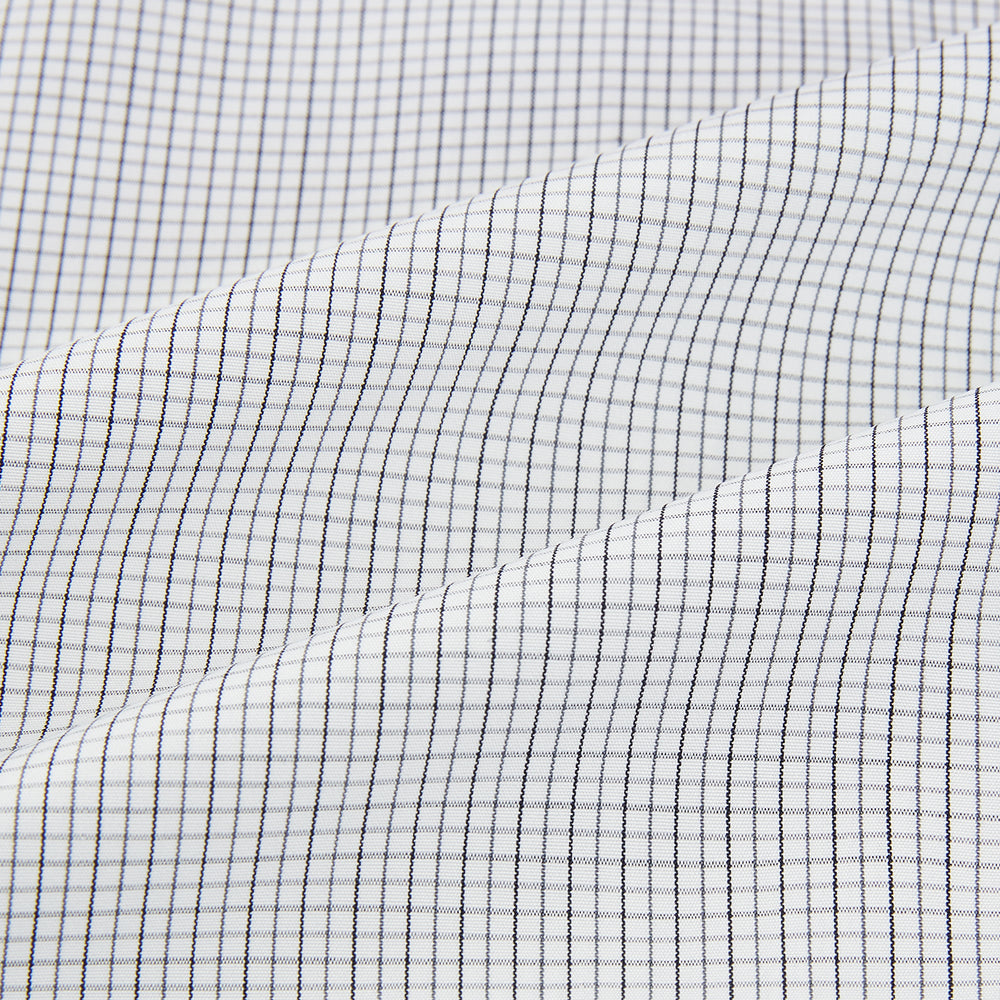 A tailored-fit Turnbull & Asser Mayfair Shirt in midnight blue with a grid check pattern, spread collar, and buttoned cuffs, crafted from premium Italian cotton and laid flat on a white background.