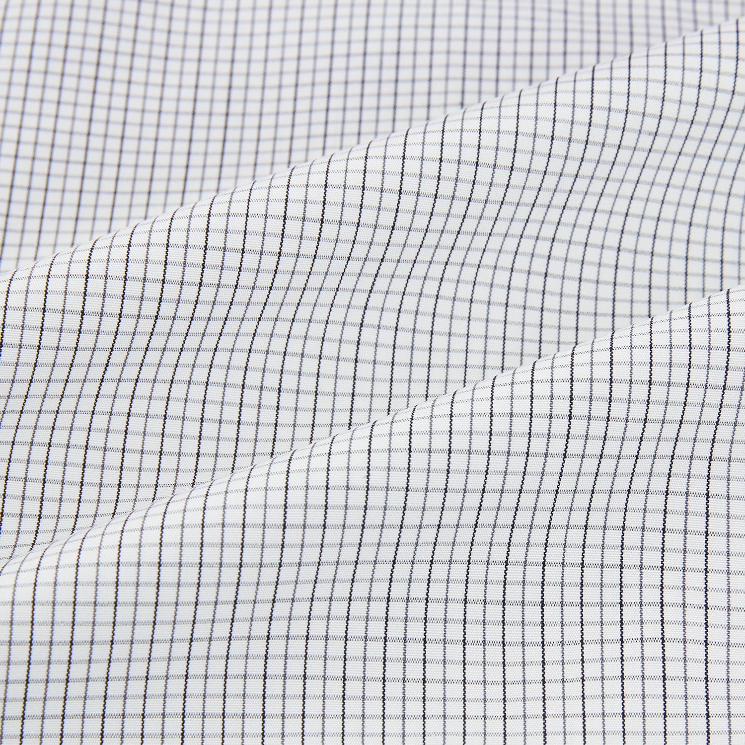 View 6 of product A tailored-fit Turnbull & Asser Mayfair Shirt in midnight blue with a grid check pattern, spread collar, and buttoned cuffs, crafted from premium Italian cotton and laid flat on a white background.