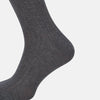 View 3 of product The Ash Mid-Length Sock by Turnbull & Asser, shown upright on a plain white background, is a single dark gray ribbed knee-high made from mercerised Egyptian cotton.