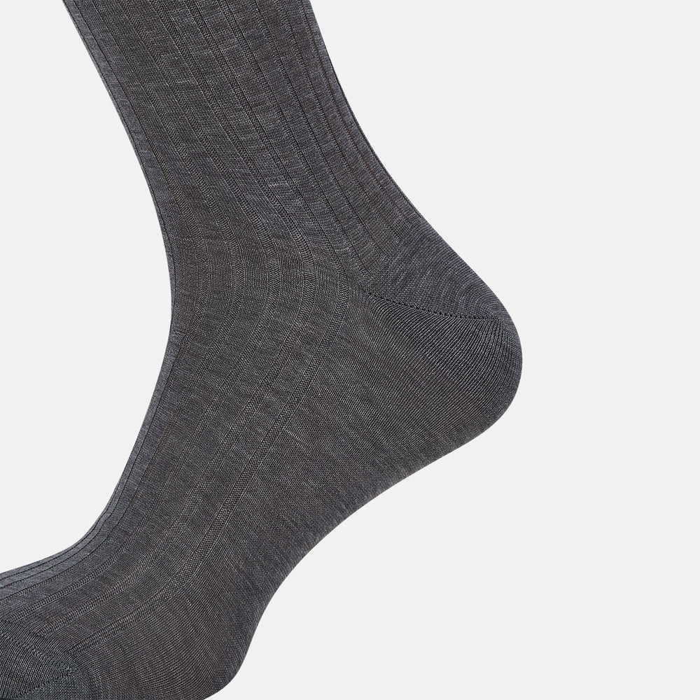 The Ash Mid-Length Sock by Turnbull & Asser, shown upright on a plain white background, is a single dark gray ribbed knee-high made from mercerised Egyptian cotton.