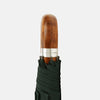 View 3 of product The Turnbull & Asser Forest Green Telescopic Umbrella features a silver shaft and a brown maple crook handle, shown fully open against a plain white background.