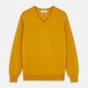 View 1 of product The Gold Paden Cashmere V-Neck Jumper by Turnbull & Asser features a bright yellow hue, long sleeves, ribbed cuffs and hem, and a classic design. It is shown laid flat on a white background.