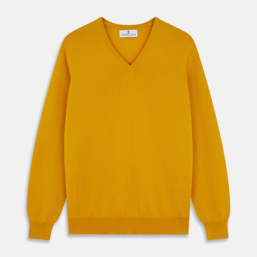 The Gold Paden Cashmere V-Neck Jumper by Turnbull & Asser features a bright yellow hue, long sleeves, ribbed cuffs and hem, and a classic design. It is shown laid flat on a white background.