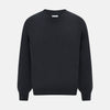 View 1 of product The Turnbull & Asser Dark Green Cashmere V-Neck Jumper features long sleeves, ribbed cuffs, and a ribbed waistband, showcased against a white background.