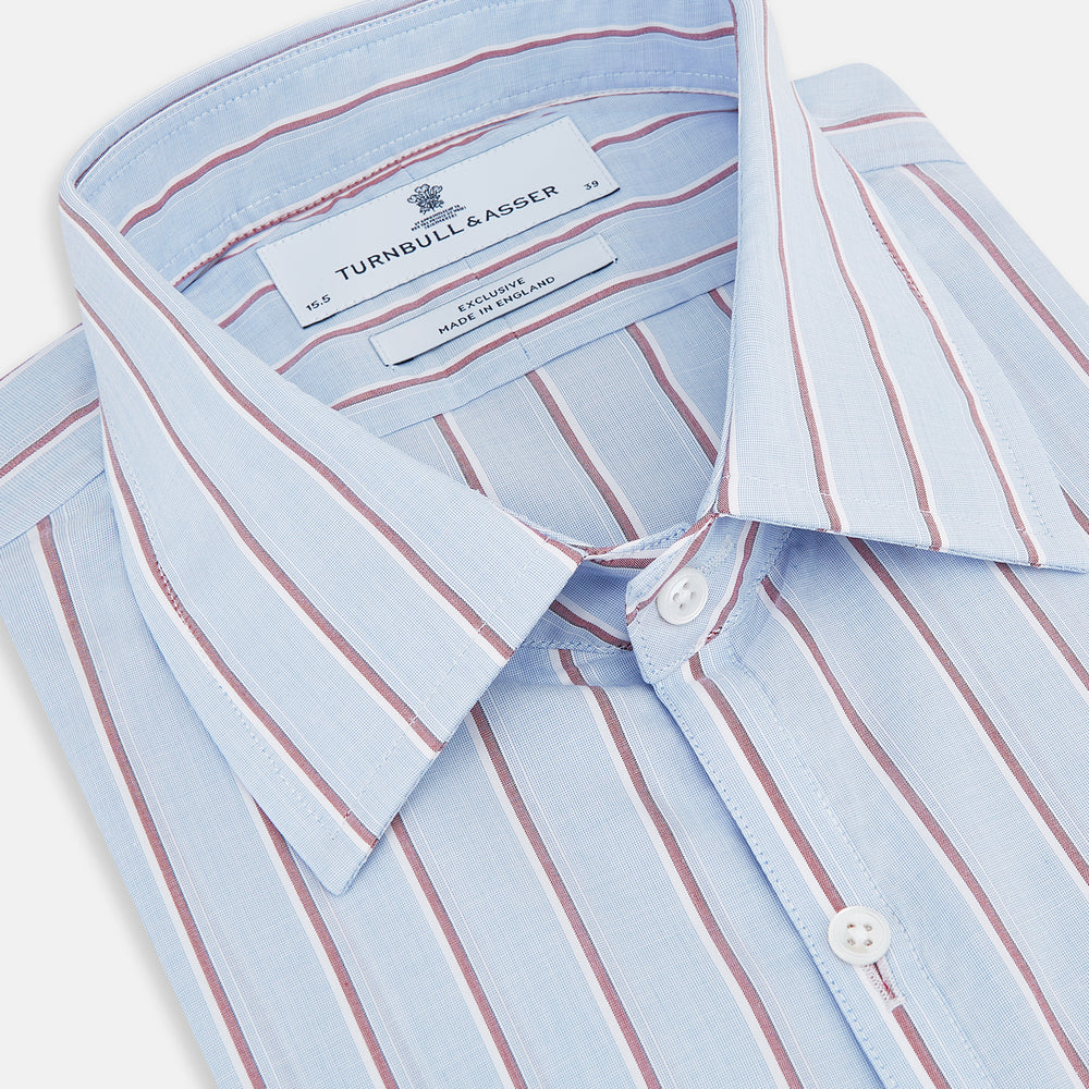 The Turnbull & Asser Blue and Burgundy Multi-Stripe Westminster Shirt features a pointed collar and long sleeves, laid flat on a white background to highlight its fine British craftsmanship.