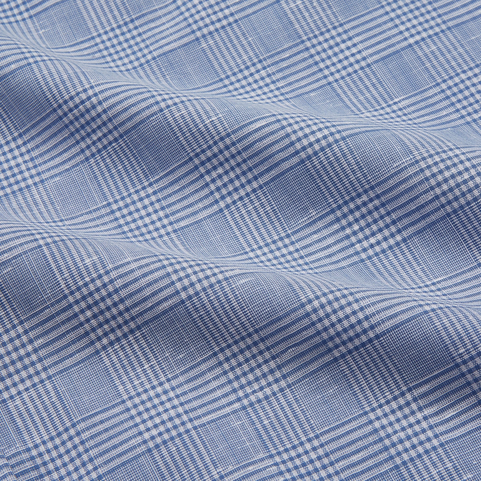 View 2 of product The Turnbull & Asser Pale Blue Multi Check Cotton Weekend Fit Williams Shirt features short sleeves, a pointed collar, single chest pocket, and premium Italian cotton with a subtle checkered pattern, shown on a white background.