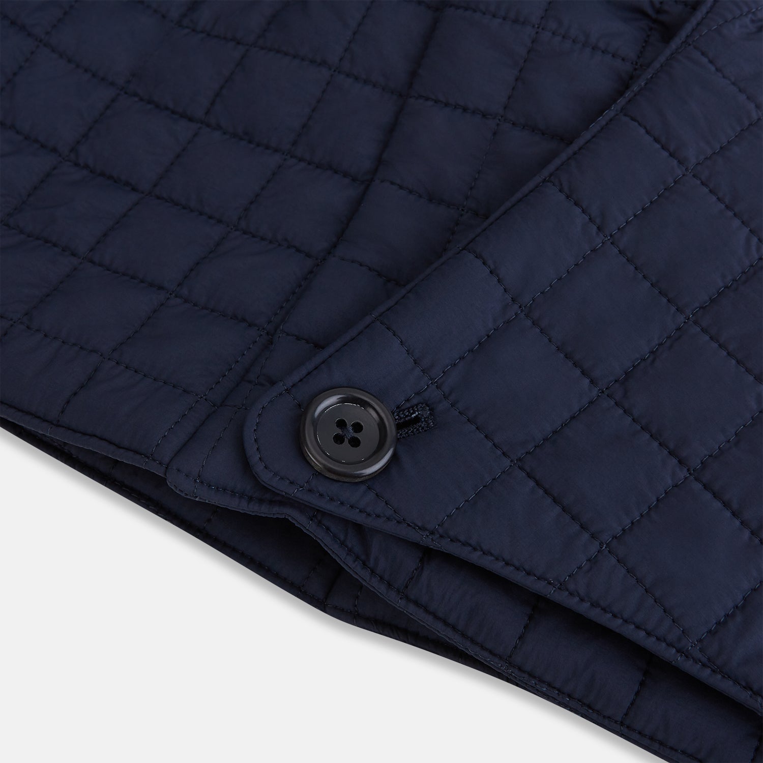 View 5 of product The Turnbull & Asser Navy Quilted Hood with Neck Warmer features diamond pattern stitching, a structured hood, overlapping collar, and button closure, shown on a plain white background.