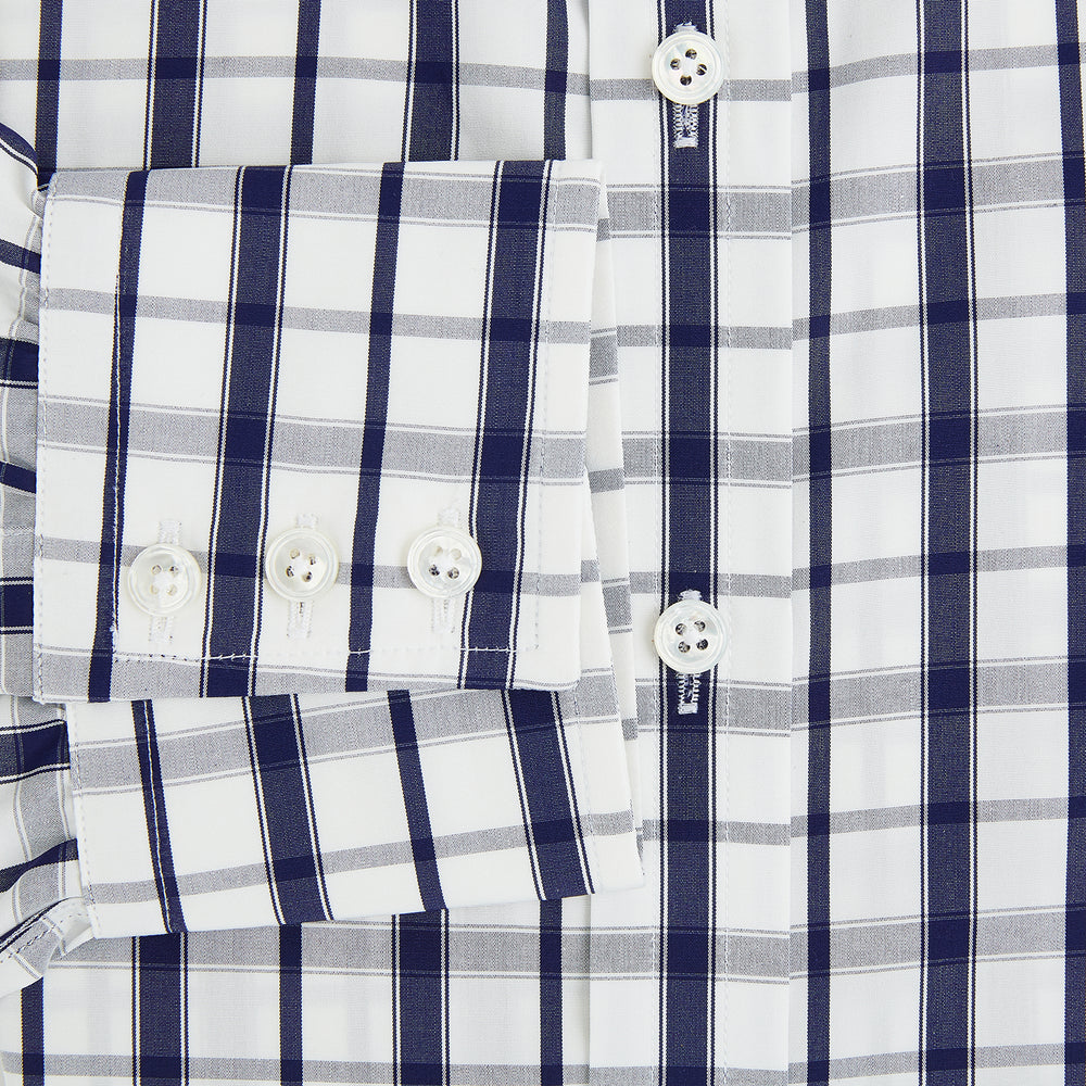 The Turnbull & Asser Navy Plaid Check Mayfair Shirt is crafted from pure cotton in white and navy checks, featuring a pointed collar and buttoned cuffs—perfect for formal looks.