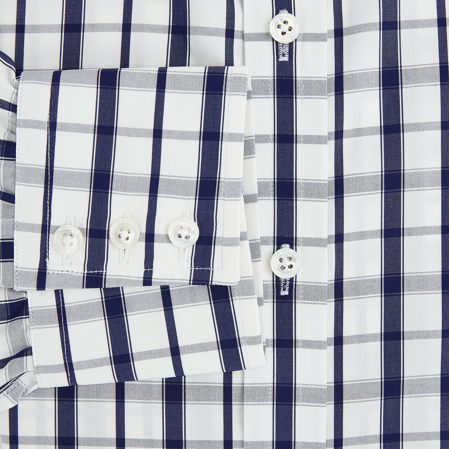 View 4 of product The Turnbull & Asser Navy Plaid Check Mayfair Shirt is crafted from pure cotton in white and navy checks, featuring a pointed collar and buttoned cuffs—perfect for formal looks.