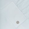 View 6 of product The Turnbull & Asser White Herringbone Superfine Cotton Shirt features a T&A collar, double cuffs, and a visible label inside the collar, shown neatly folded on a light blue background—ideal for minimalist looks or pairing with bold ties.