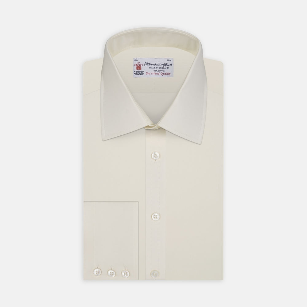 A close-up of Turnbull & Asser’s Cream Sea Island Quality Cotton Fabric is shown in a circular frame with a gray border, emphasizing its smooth texture and subtle stitching on the right side.