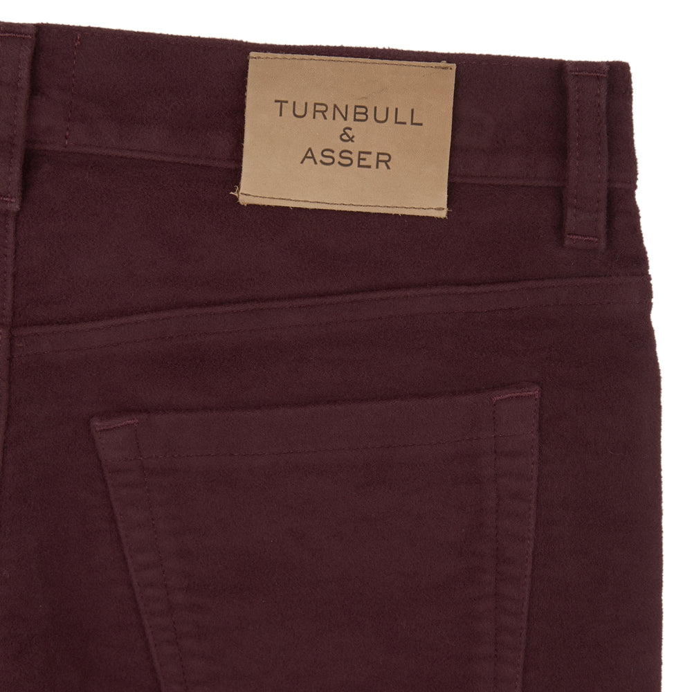 A pair of Purple 5 Pocket Jeans by Turnbull & Asser, featuring a straight-leg, high-waisted design with front and back pockets, displayed against a plain white background.