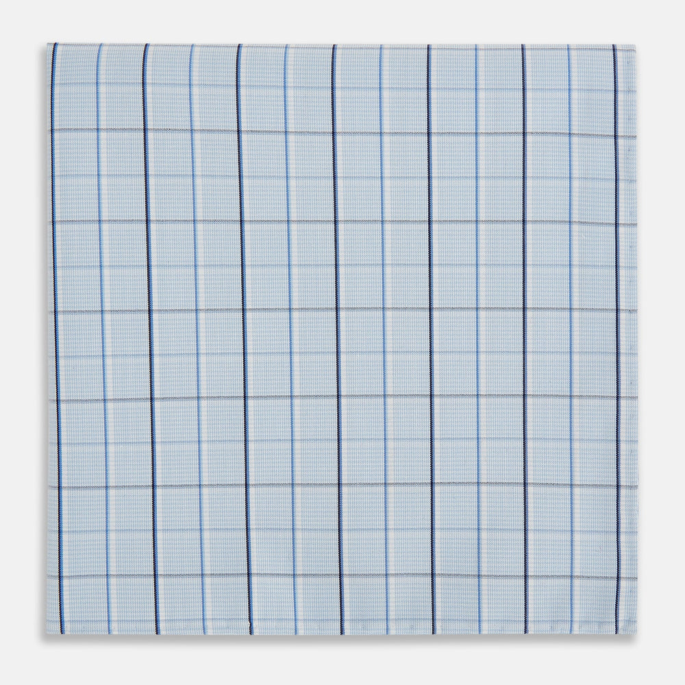 The Turnbull & Asser Navy and Blue Combination Check Hand-Rolled Handkerchief features a classic check pattern in navy and blue with thin white lines, shown laid flat on a white background.