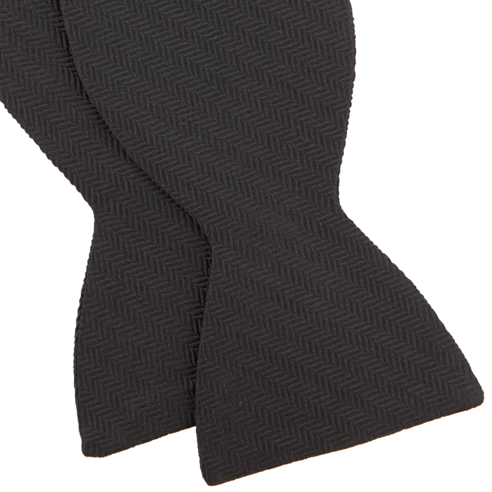 View 4 of product The Turnbull & Asser Black Herringbone Silk Bow Tie, ideal for formal occasions, features a subtle herringbone pattern and is shown against a plain white background.