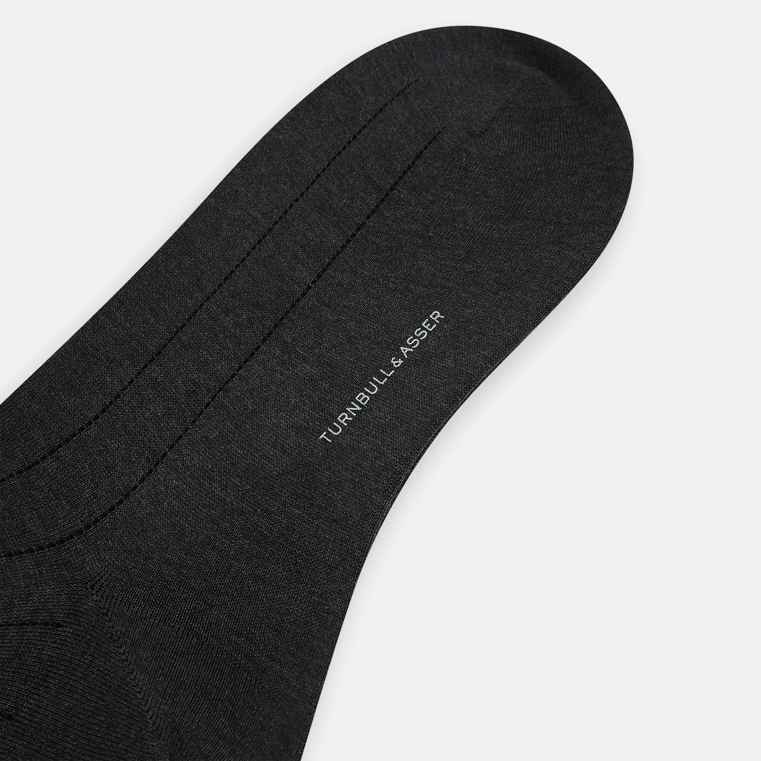 View 3 of product A single Charcoal/Brown Dash Striped Long Sock by Turnbull & Asser, made from mercerised Egyptian cotton, stands upright on a plain light background, showcasing its ribbed texture and fitted design.