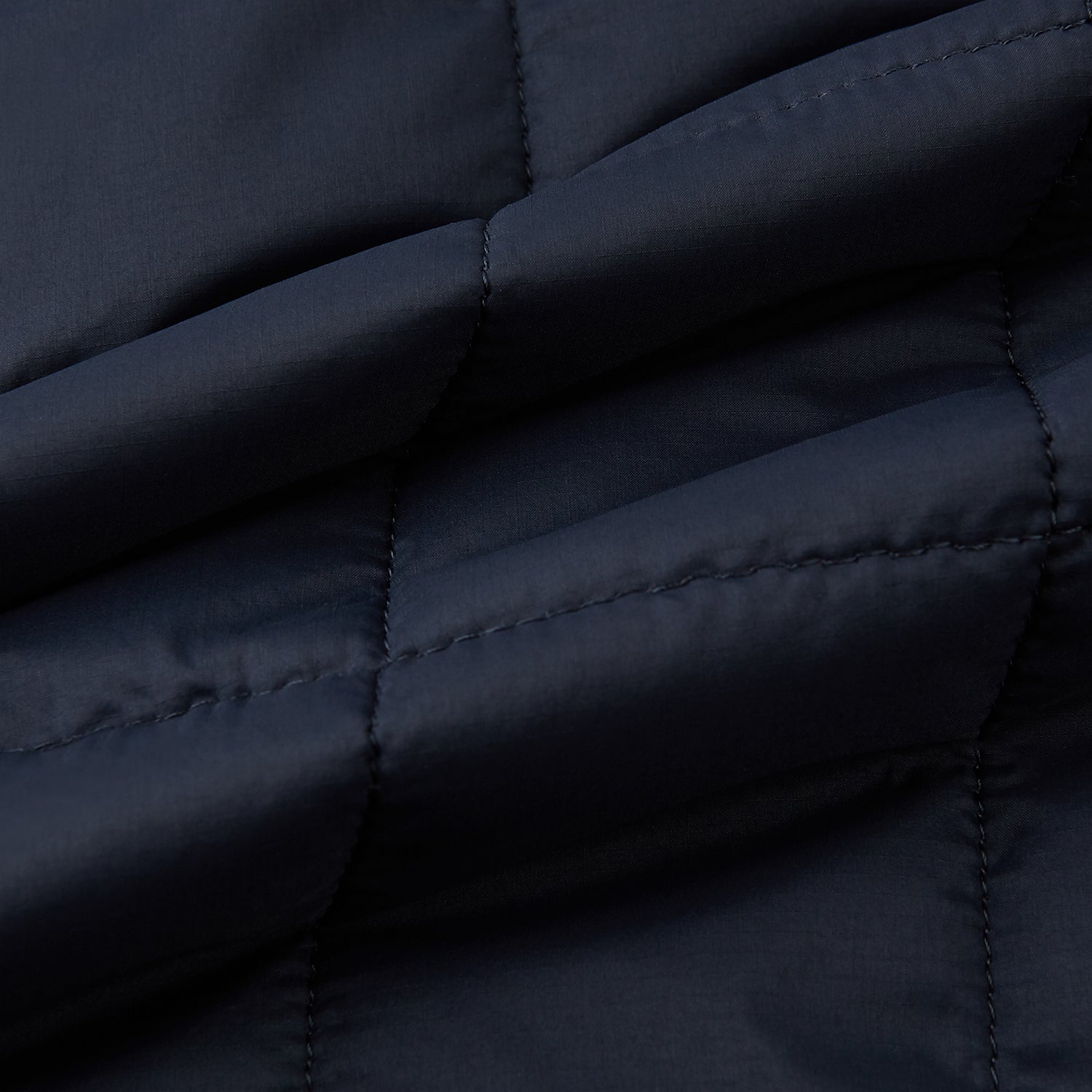 View 4 of product The Turnbull & Asser Battersea Navy Quilted Jacket features a versatile quilted design with a front zipper, zippered pockets, collared neckline, buttoned cuffs, and a subtle square pattern—perfect for the modern gentleman.