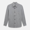 View 1 of product The Turnbull & Asser Grey Check Hampstead Overshirt features a light gray check pattern, pointed collar, chest pocket, and two zippered side pockets, displayed flat against a white background.