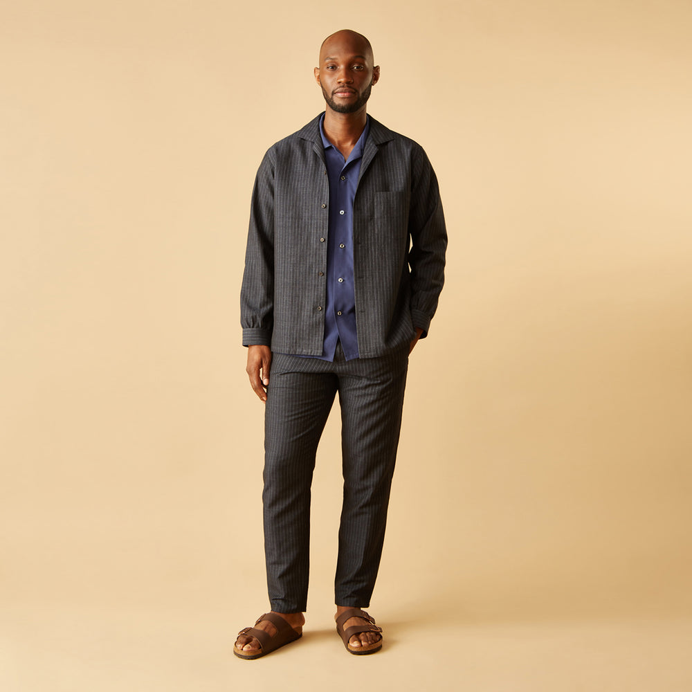 The Navy Tailored Pinstriped Shirt Jacket by Turnbull & Asser is a smart-casual, lightweight cotton-linen piece with long sleeves, a collar, left chest pocket, and front buttons for easy style.