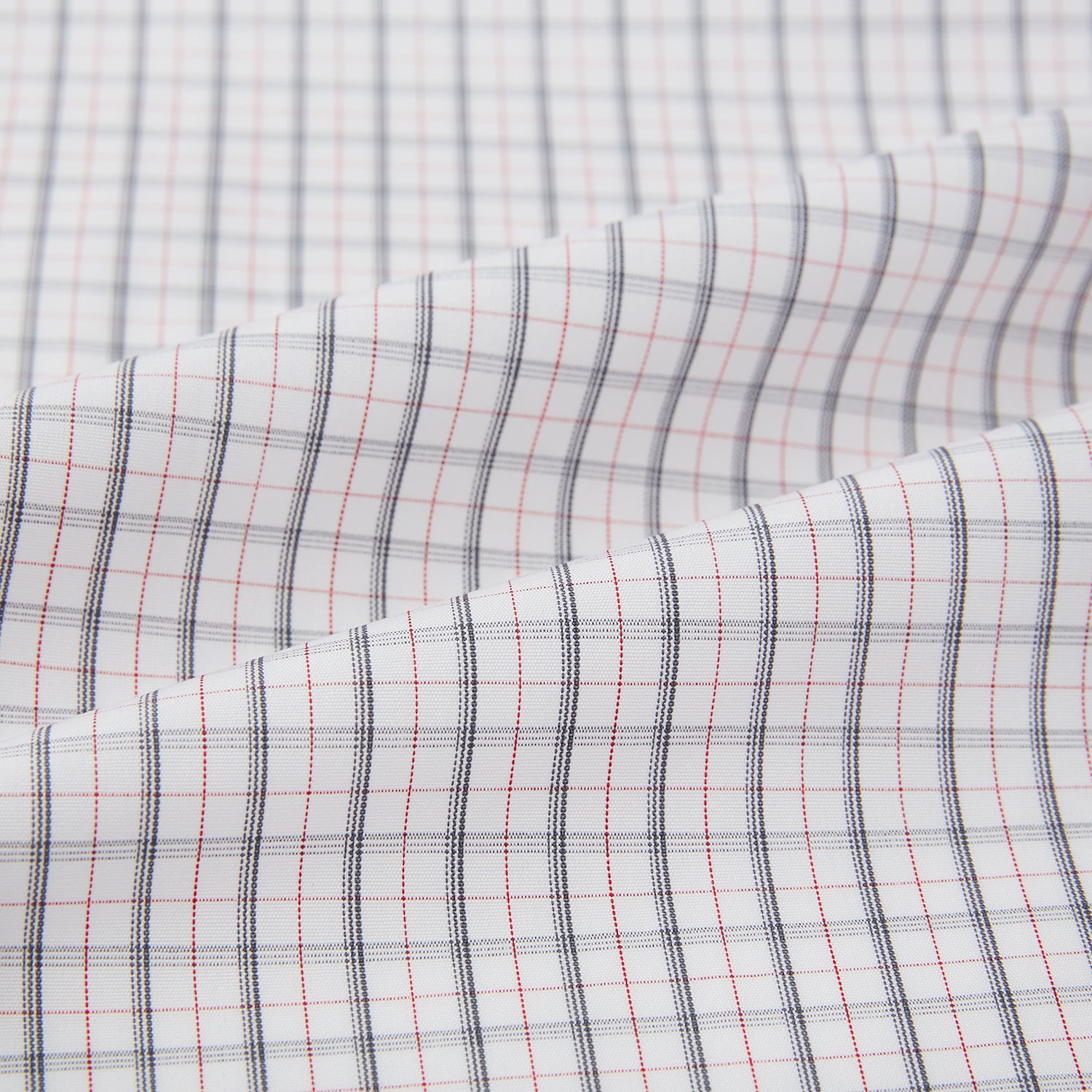 View 7 of product The Blue and Red Graph Check Westminster Shirt by Turnbull & Asser features a classic collar, long sleeves, and British craftsmanship, with a blue and red checkered pattern on white, displayed flat on a white surface.