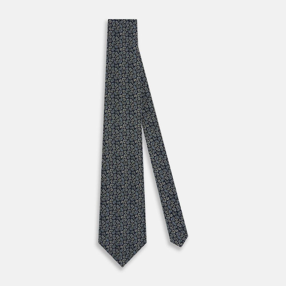 The Turnbull & Asser Navy Paisley Foulard Silk Tie features a refined paisley pattern in blue, white, and beige tones, elegantly rolled and presented against a white background.