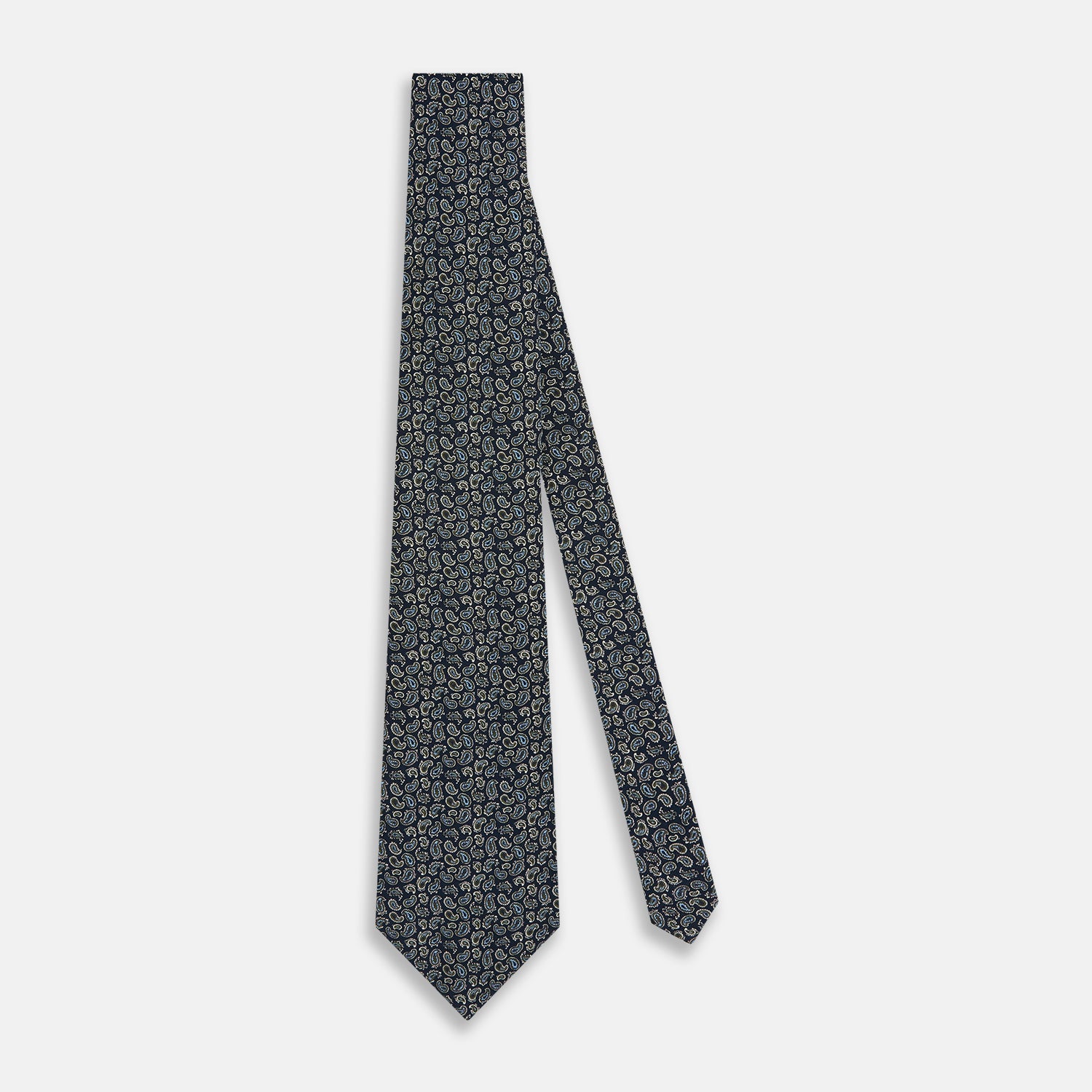 View 2 of product The Turnbull & Asser Navy Paisley Foulard Silk Tie features a refined paisley pattern in blue, white, and beige tones, elegantly rolled and presented against a white background.