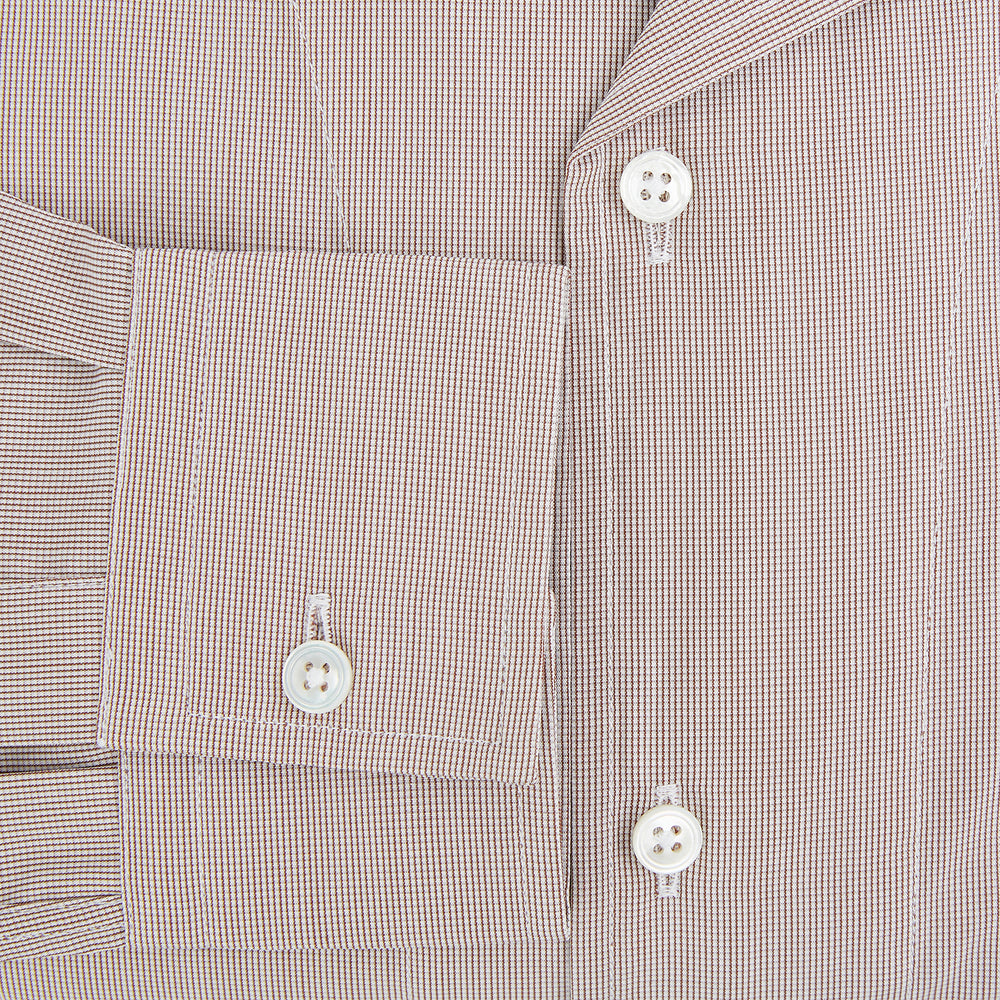 The Turnbull & Asser Brown Micro Check Quarzo Nightshirt is a long-sleeve shirt dress inspired by classic sleepwear, featuring a collar, chest pocket, upper front buttons, and a subtle micro check pattern on a white background.