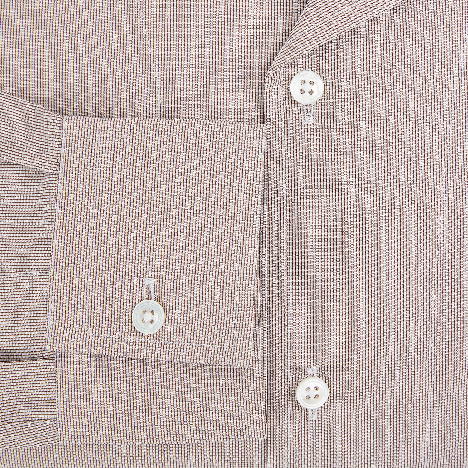 View 4 of product The Turnbull & Asser Brown Micro Check Quarzo Nightshirt is a long-sleeve shirt dress inspired by classic sleepwear, featuring a collar, chest pocket, upper front buttons, and a subtle micro check pattern on a white background.