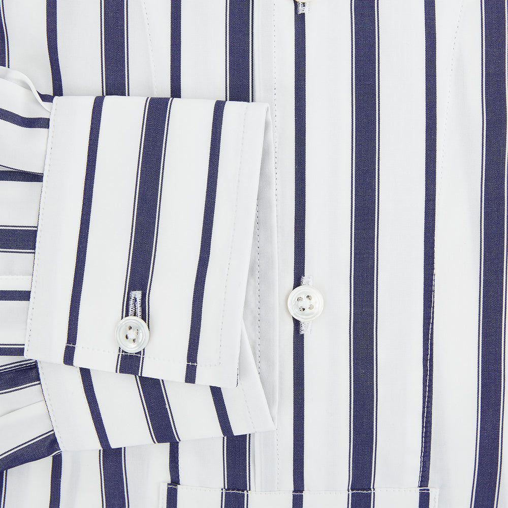 The Turnbull & Asser Navy Double Stripe Quarzo Nightshirt, a knee-length Italian cotton nightshirt with navy and white vertical stripes, collar, chest pocket, and button-down front, is displayed flat on a white background.