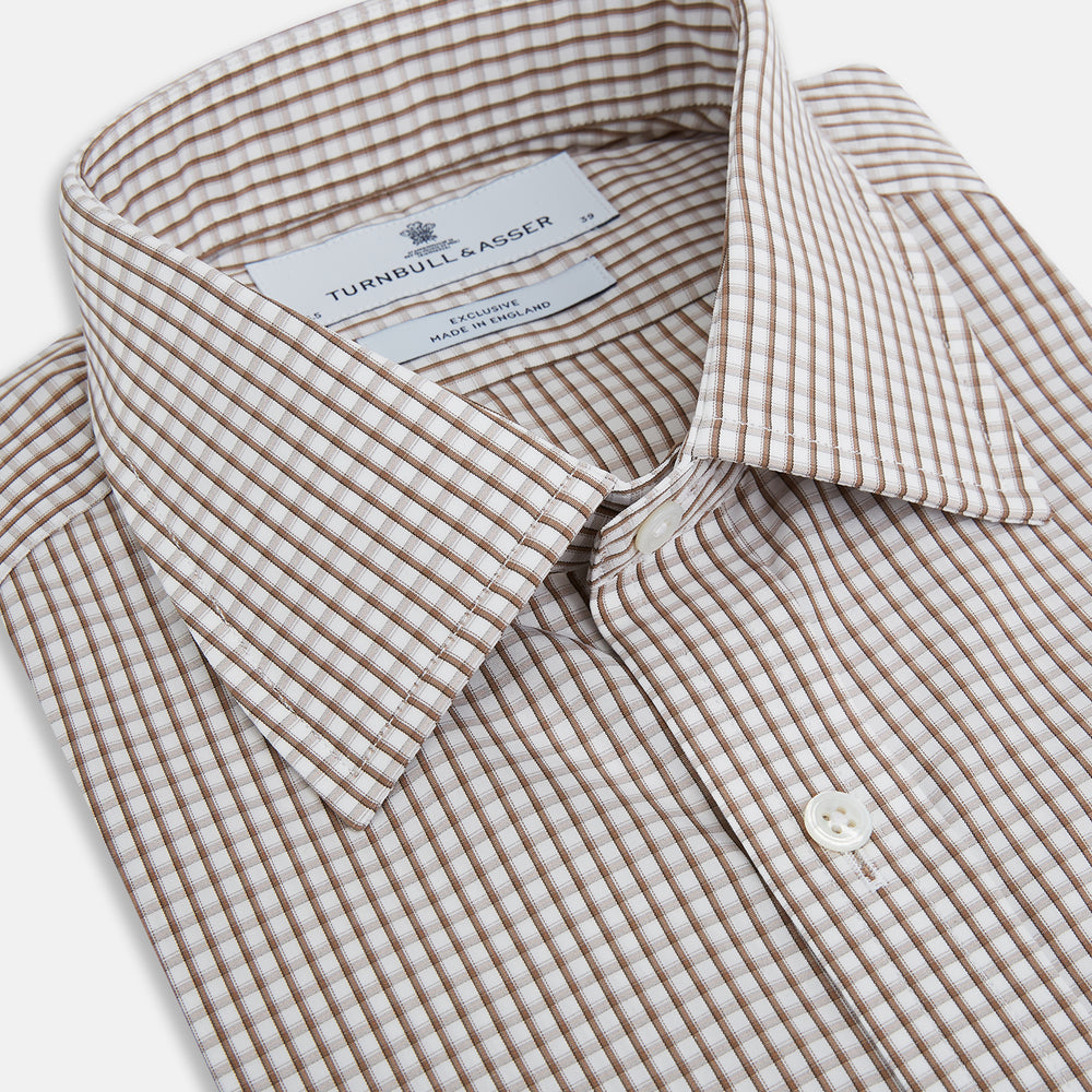 The Coffee Micro Shadow Check Mayfair Shirt by Turnbull & Asser is a long-sleeved, button-up shirt made from fine Italian cotton with a small brown and white check pattern, classic collar, and buttoned cuffs—an essential for any man’s wardrobe.