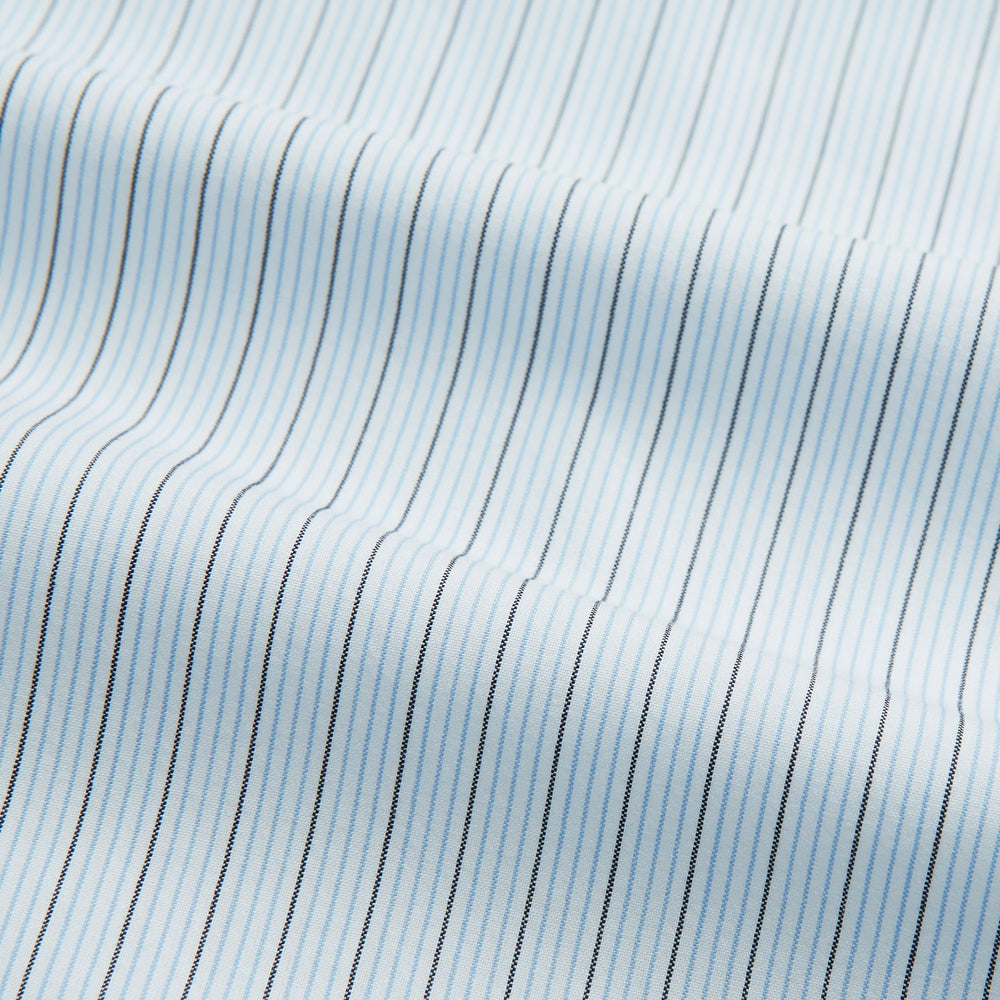 The Turnbull & Asser Hand Rolled Blue Multi Stripe Handkerchief features light blue cotton with thin black and white stripes, making it a refined accessory for the gentleman.