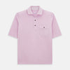 View 1 of product The Turnbull & Asser Pink Polo Shirt is a men's cotton polo with short sleeves, a collar, three dark buttons, and a chest pocket with a button, shown laid flat on a white background.