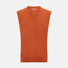 View 1 of product The Turnbull & Asser Orange Cashmere V-Neck Vest adds vibrant style to men’s fashion, featuring a ribbed hem and sleeveless design. Shown against a plain white background.