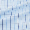 View 6 of product The Navy and Blue Combination Check Mayfair Shirt by Turnbull & Asser features a light blue base with a grid of thin dark blue lines, long sleeves, a pointed collar, and is neatly displayed on a plain white background.