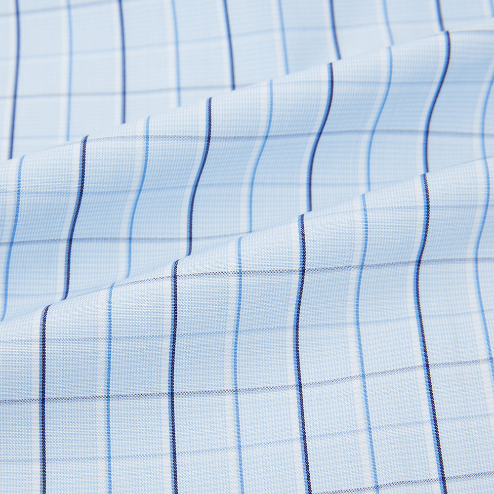 The Navy and Blue Combination Check Mayfair Shirt by Turnbull & Asser features a light blue base with a grid of thin dark blue lines, long sleeves, a pointed collar, and is neatly displayed on a plain white background.